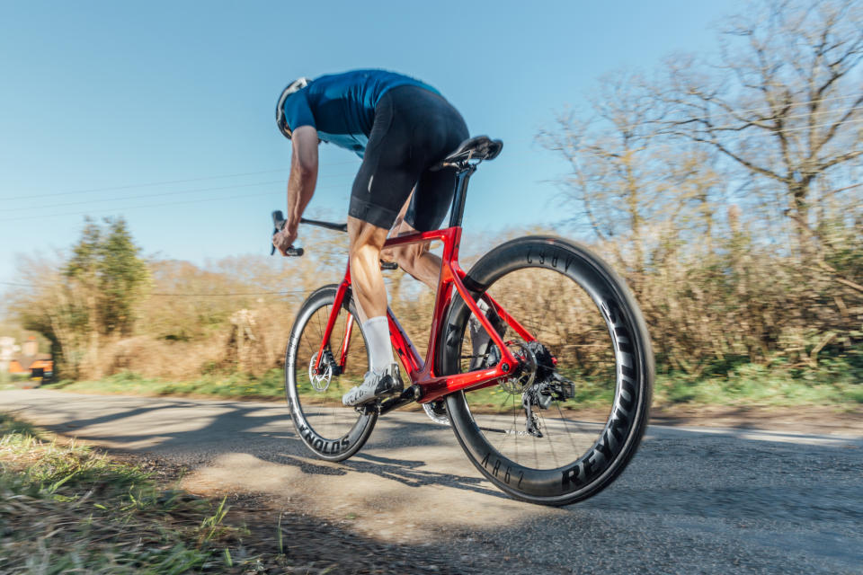 Male cyclist accelerating out of the saddle