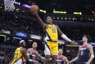 Indiana Pacers guard Bennedict Mathurin (00) shoots against Washington Wizards forward Deni Avdija (9) during the first half of an NBA basketball game, Friday, Dec. 9, 2022, in Indianapolis. (AP Photo/Darron Cummings)