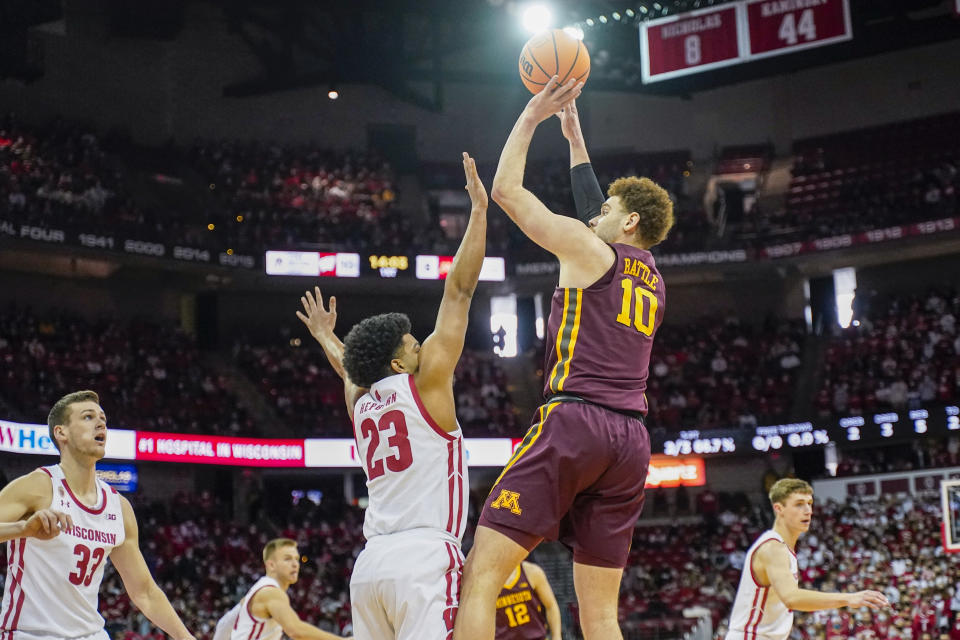 Minnesota's Jamison Battle (10) shoots against Wisconsin's Chucky Hepburn (23) during the first half of an NCAA college basketball game Sunday, Jan. 30, 2022, in Madison, Wis. (AP Photo/Andy Manis)