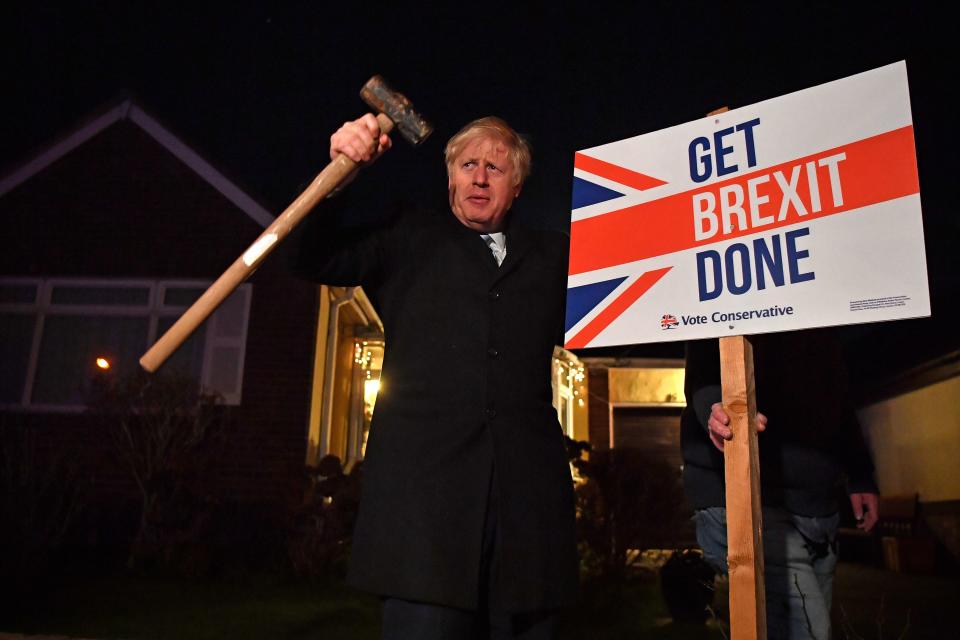 TOPSHOT - Britain's Prime Minister and Conservative party leader Boris Johnson poses after hammering a 