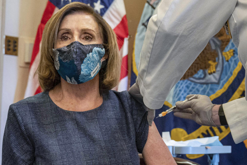 FILE - In this Friday, Dec. 18, 2020, file photo, Speaker of the House Nancy Pelosi, D-Calif., receives a Pfizer-BioNTech COVID-19 vaccine shot from Dr. Brian Monahan, the Capitol physician, in Washington. On Thursday, Dec. 24, 2020, The Associated Press reported on stories circulating online incorrectly asserting that the doctor never removed a cap from the syringe, so she never actually received the shot. Photos and news reports clearly document every step of the process of her successfully receiving the injection. (Ken Cedeno/Pool via AP)