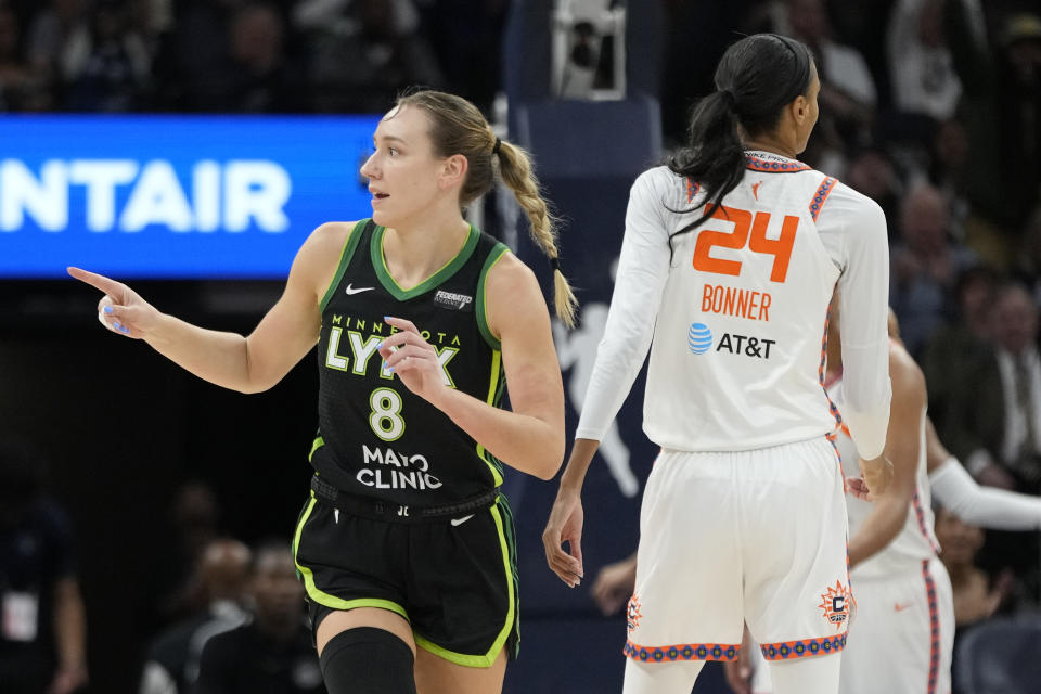 Minnesota Lynx forward Alanna Smith (8) points after making a shot during the first half of Game 5 of a WNBA basketball semifinals game against the Connecticut Sun, Tuesday, Oct. 8, 2024, in Minneapolis. (AP Photo/Abbie Parr)