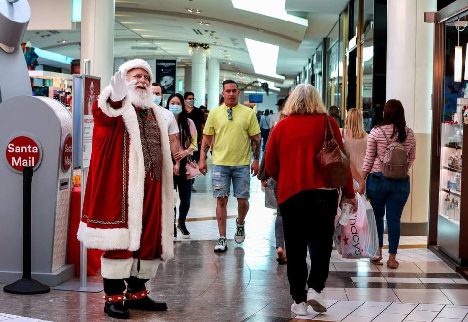 File photo finds Santa waving to shoppers at Dadeland Mall as they hit the mall for Black Friday deals on Friday, Nov. 26, 2021. Pedro Portal/pportal@miamiherald.com