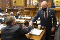 Georgia State Sen. Mike Dugan (R-Carrollton) shakes hands with Rules Committee Chairman Sen. Jeff Mullis (R-Chickamauga) after the passage of Senate Bill 241, which changes Georgia's voting laws, Monday, March 8, 2021, at the State Capitol in Atlanta. Dugan presented the bill. (AP Photo/Ben Gray)