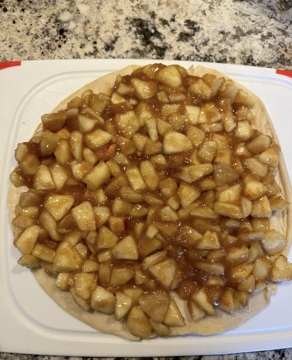 diced apples on a frozen pie crust