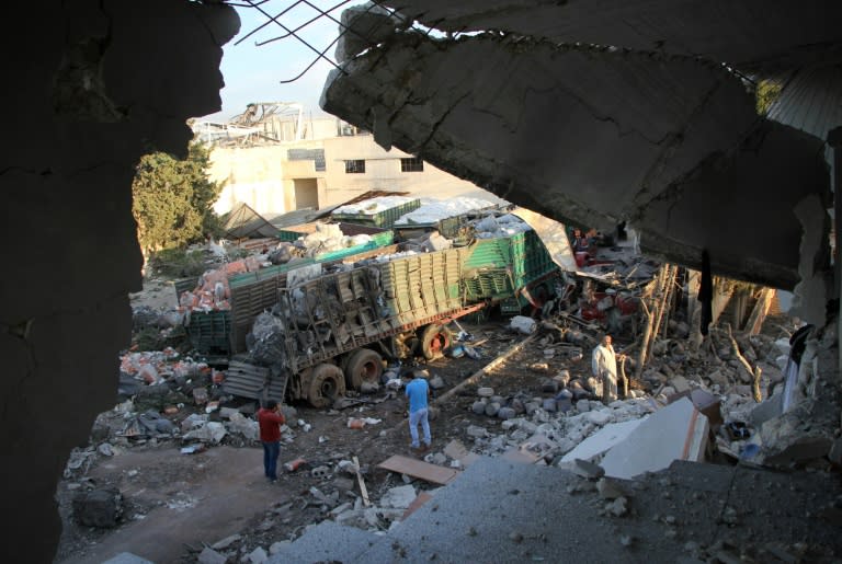 Aid is seen strewn across the ground in the town of Orum al-Kubra on the western outskirts of Aleppo on September 20, 2016, the morning after a convoy delivering aid was hit by a deadly air strike