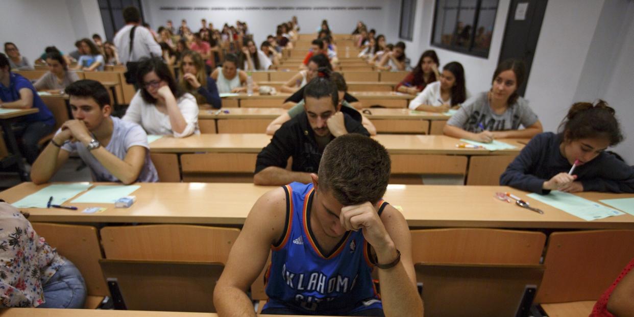 Students take a university entrance examination at a lecture hall in the Andalusian capital of Seville, southern Spain, June 16, 2015.