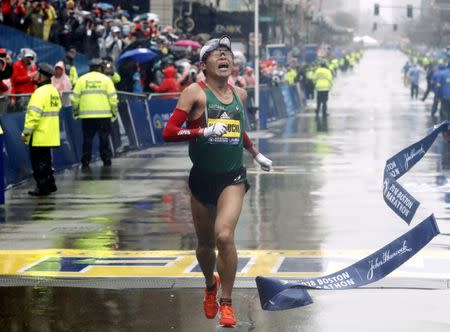 Apr 16, 2018; Boston, MA, USA; Yuki Kawauchi of Japan hits the tape to win the Men's Division of the 2018 Boston Marathon. Mandatory Credit: Winslow Townson-USA TODAY Sports