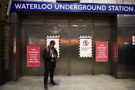 A traveller stands at the closed entrance to the Underground station at Waterloo during a strike by members of two unions in protest at ticket office closures and reduced staffing levels, in London, Britain January 9, 2017. REUTERS/Dylan Martinez