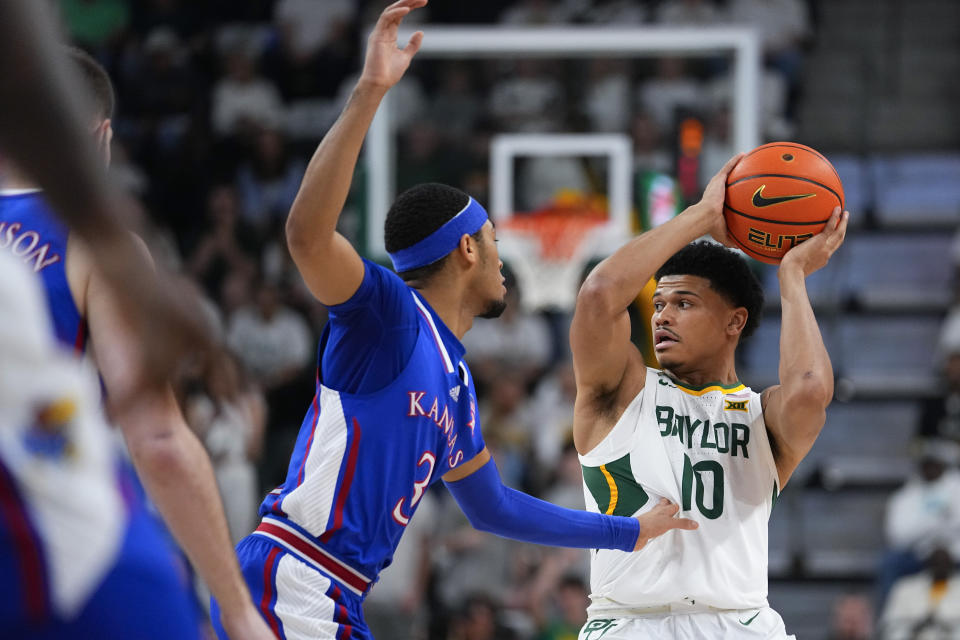 Baylor's RayJ Dennis (10) works the floor against Kansas's Dajuan Harris Jr. during the first half of an NCAA college basketball game, Saturday, March 2, 2024, in Waco, Texas. (AP Photo/Julio Cortez)