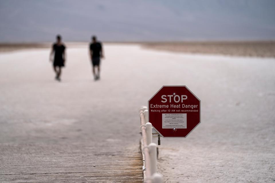 A sign warns hikers of extreme heat on the salt flats of Badwater Basin in Death Valley National Park, Calif., where the temperature reached 128 degrees on July 10, according to the National Weather Service.