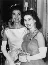 <p>Queen Elizabeth poses with Jackie Kennedy, the First Lady of the United States at the time, during a dinner at Buckingham Palace. It was the first time the president of the United States had been invited to dine at Buckingham Palace since 1918.</p>