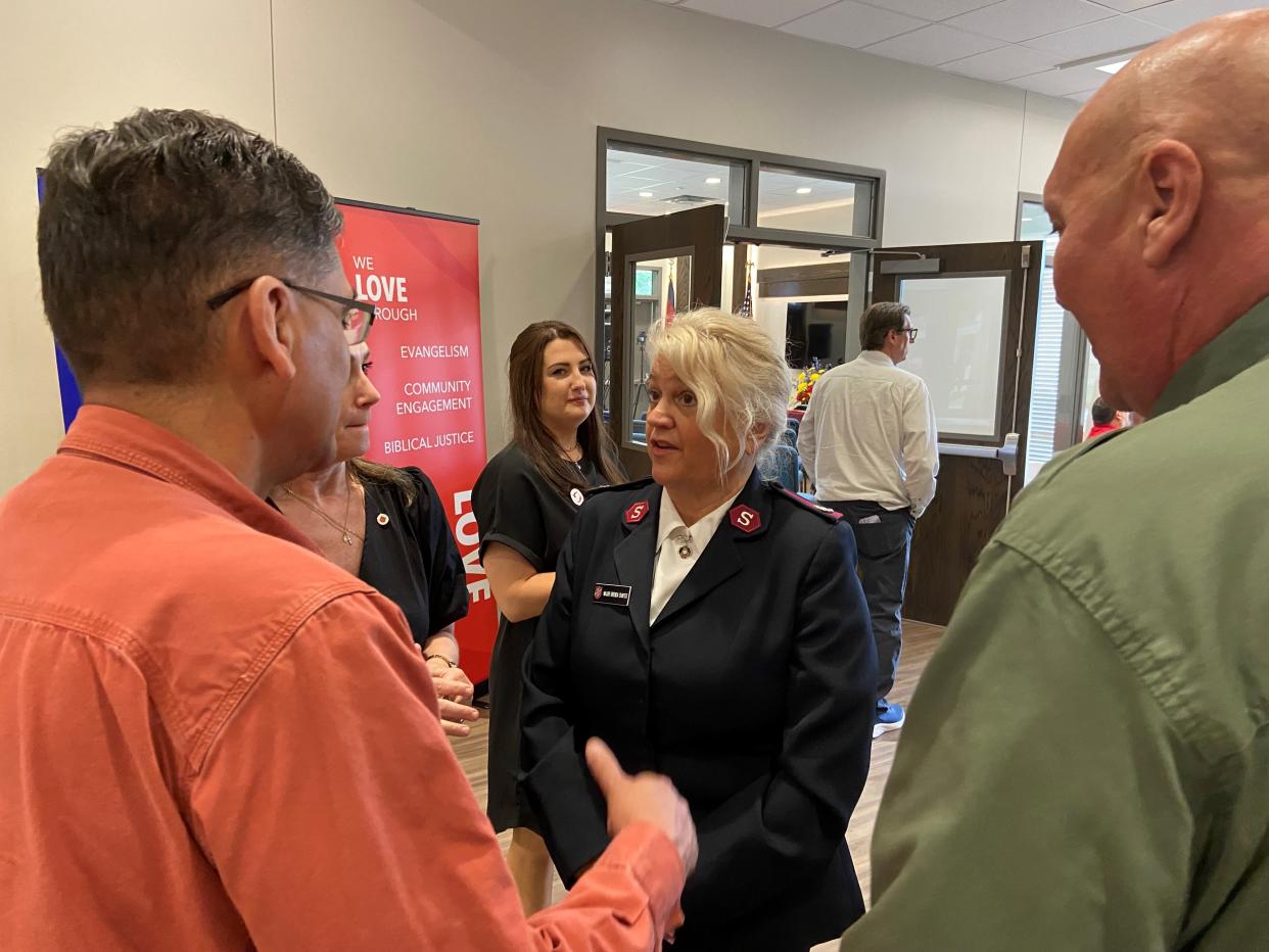 Major Brenda Shafer speaks with people who came to the grand opening and dedication of the Salvation Army's new Center of Hope, which will provide housing for homeless men, women and families.