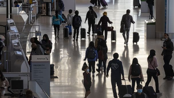 PHOTO: Travelers walk through the terminal at the International Airport in San Francisco,  Nov. 24, 2021.  (Bloomberg via Getty Images, FILE)