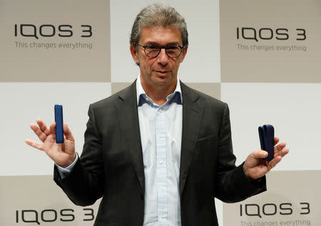 Philip Morris International's CEO Andre Calantzopoulos poses with its new IQOS 3 devices at a news conference in Tokyo, Japan, October 23, 2018. REUTERS/Kim Kyung-Hoon