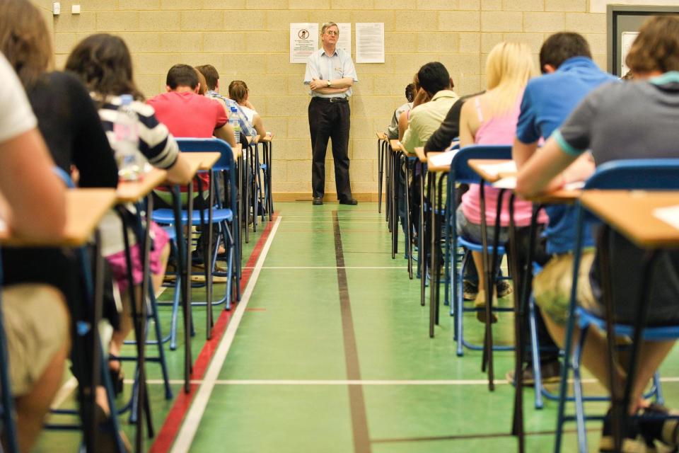 Students sitting exams in a previous year (PA)