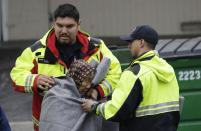 A woman is wrapped in a blanket by rescue crews in a flooded neighborhood Tuesday, Feb. 21, 2017, in San Jose, Calif. Rescuers chest-deep in water steered boats carrying dozens of people, some with babies and pets, from a San Jose neighborhood inundated by water from an overflowing creek Tuesday. (AP Photo/Marcio Jose Sanchez)