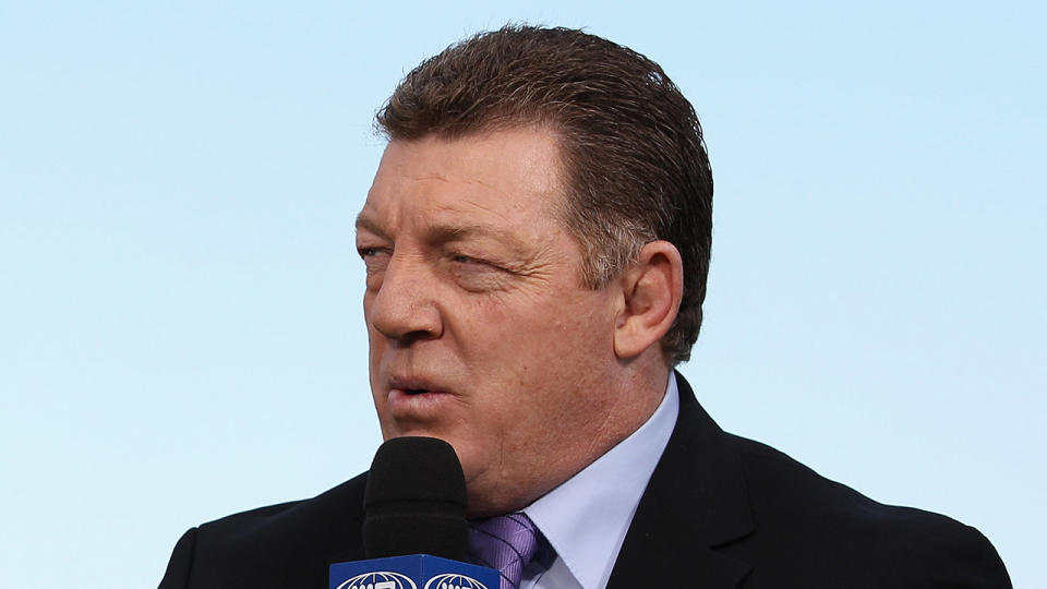Gus Gould looks at the commentator as he speaks on Channel Nine.