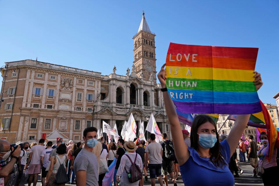 People take part in the annual Pride march, in Rome, Saturday, June 26, 2021. This year's march comes amid widespread concern in Europe about legislation in Hungary that will ban showing content about LGBT issues to children and a controversial Vatican communication to Italy, criticizing a law that would extend additional protections from discrimination to the LGBT community.