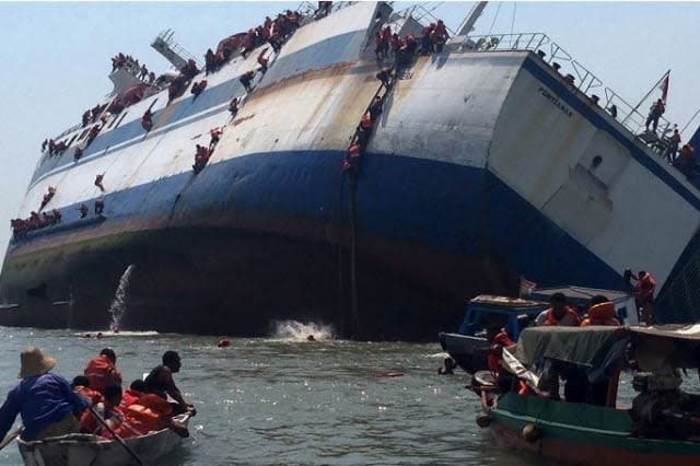 Photos show passengers clinging to sinking ship