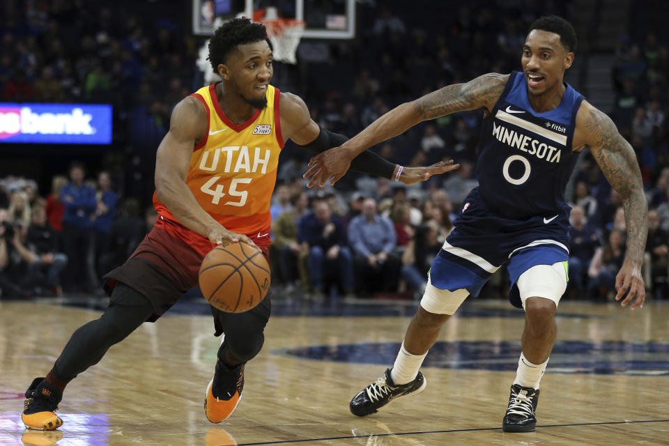Utah Jazz's Donovan Mitchell controls the ball against Minnesota Timberwolves' Jeff Teague in the first half of an NBA basketball game Wednesday, Dec. 11, 2019, in Minneapolis. (AP Photo/Stacy Bengs)