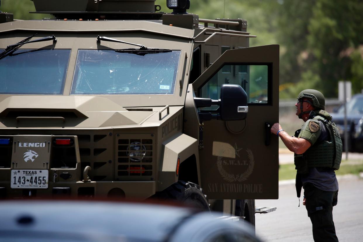 Law enforcement personnel stand next to an armored vehicle outside Robb Elementary School following a shooting, Tuesday, May 24, 2022, in Uvalde, Texas. 