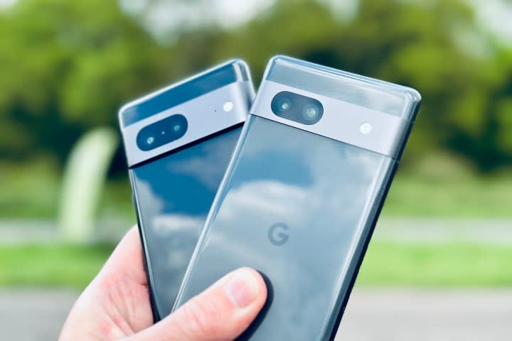 The Google Pixel 7 and Pixel 7a held in a person's hand.