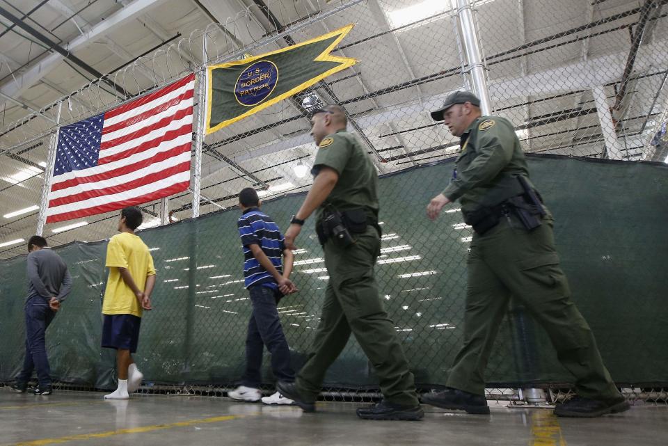 Detainees are escorted to an area to make phone calls as hundreds of mostly Central American immigrant children are being processed and held at the U.S. Customs and Border Protection (CBP) Nogales Placement Center in Nogales, Arizona, June 18, 2014. CBP provided media tours Wednesday of two locations in Brownsville, Texas, and Nogales, that have been central to processing the more than 47,000 unaccompanied children who have entered the country illegally since October 1, 2013. (REUTERS/Ross D. Franklin/Pool)