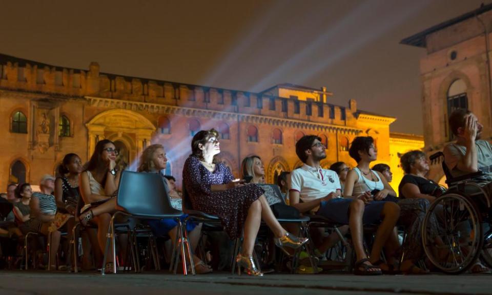 People enjoying a film under the stars at the Piazza Maggiore.