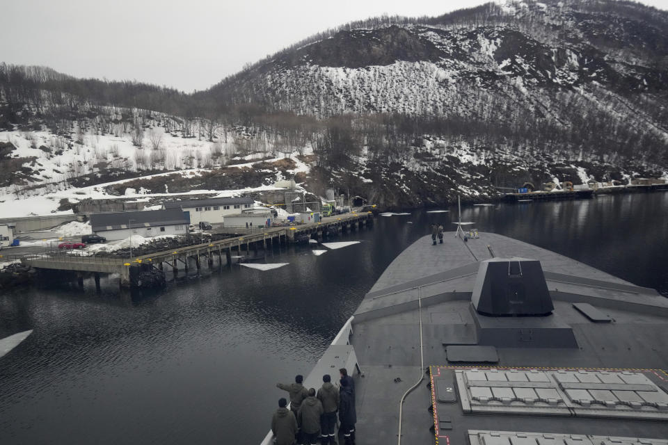 French sailors watch the docking manoeuvre of the French navy frigate Normandie for a port call in a Norwegian fjord, north of the Arctic circle, Friday March 8, 2024. The French frigate is part of a NATO force conducting exercises in the seas, north of Norway, codenamed Steadfast Defender, which are the largest conducted by the 31 nation military alliance since the cold war. (AP Photo/Thibault Camus)