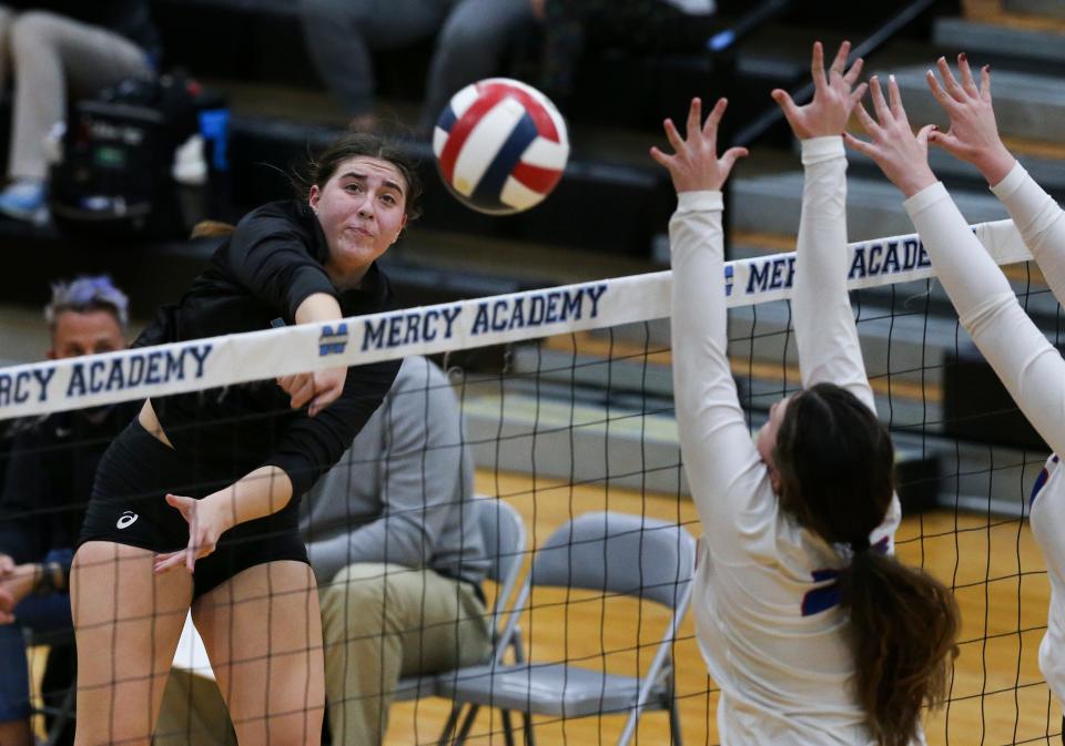 Mercy's Maddie Hagan (39) goes for a kill against the Oldham County defense during the state volleyball tournament at the Mercy Academy in Louisville, Ky. on Nov. 1, 2021.  Mercy won the match in 3 sets.