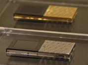 Mobile phones plated in stainless steel and 18-carat gold (top), with a price tag of HK$79,750 ($10,249) and HK$462,000 ($59,380) respectively, are shown at a luxury goods department store in Hong Kong October 20, 2011.