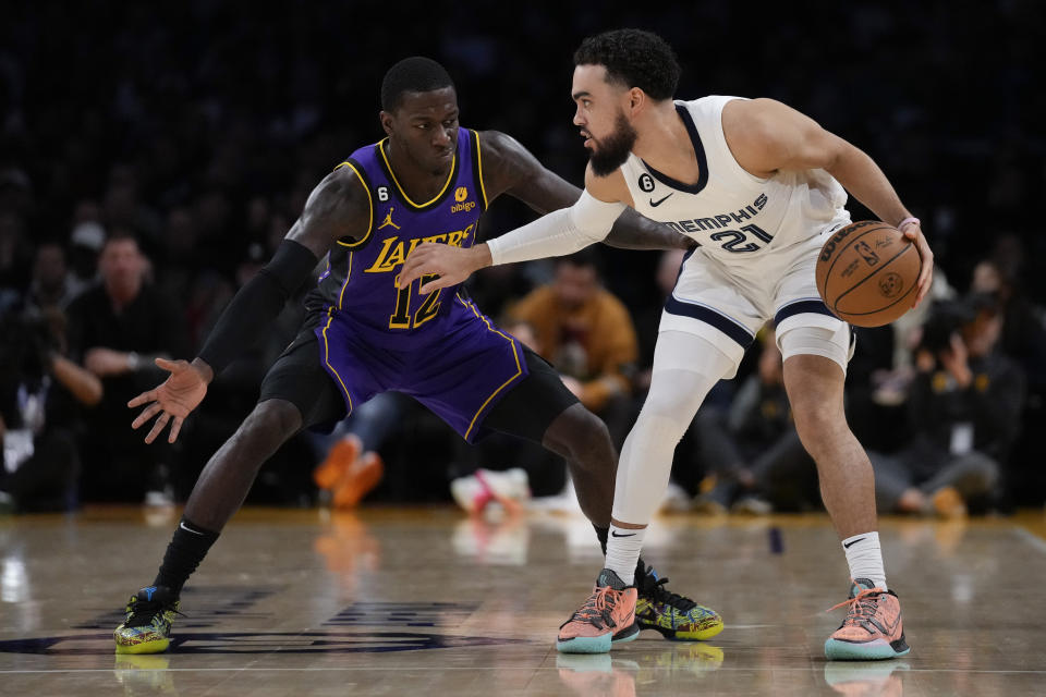 Los Angeles Lakers guard Kendrick Nunn (12) defends against Memphis Grizzlies guard Tyus Jones (21) during the second half of an NBA basketball game in Los Angeles, Friday, Jan. 20, 2023. (AP Photo/Ashley Landis)