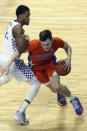 Florida's Colin Castleton, right, drives while defended by Kentucky's Keion Brooks Jr. during the first half of an NCAA college basketball game in Lexington, Ky., Saturday, Feb. 27, 2021. (AP Photo/James Crisp)