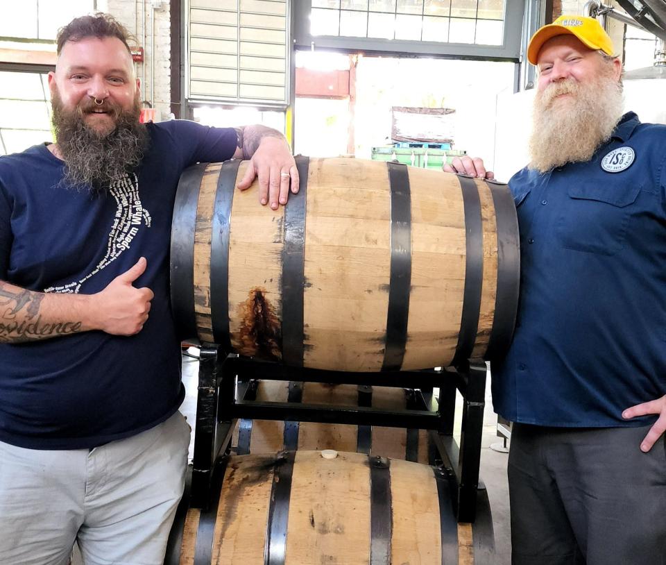 ISCO head distillers Dan Neff (left), also a company founder, and Eric Olson, with barrels of Blue Velvet Bourbon ready to be bottled.