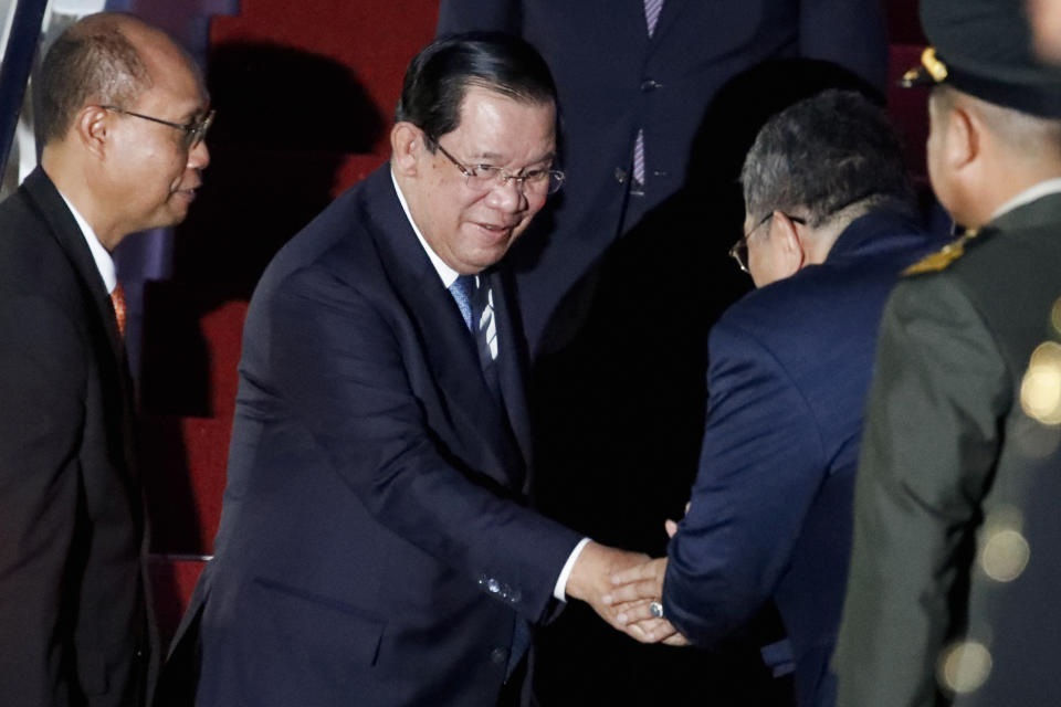 Cambodia's Prime Minister Hun Sen, center, arrives at Ngurah Rai International Airport ahead of the G20 Summit in Bali, Indonesia on Nov. 14, 2022. Hun Sen tests positive for COVID-19 at G-20, days after hosting world leaders at summit in Phnom Penh. (Ajeng Dinar Ulfiana/Pool Photo via AP)