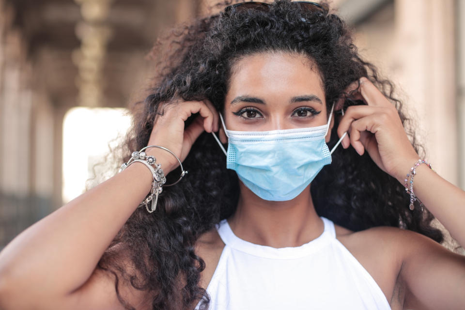 Beautiful young woman wearing surgical mask during covid-19 pandemic lockdown