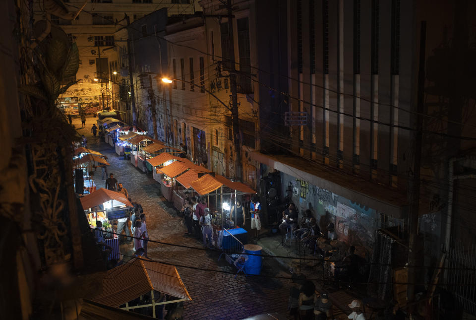 Brazilian band Atitude Nossa plays samba at a street as the restrictions related to the COVID-19 pandemic are eased in Rio de Janeiro, Brazil, Monday, Oct. 5, 2020. Since the beginning of October, live shows are now permitted in Rio de Janeiro. (AP Photo/Silvia Izquierdo)