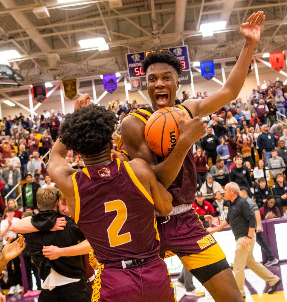 North's JaQualon Roberts (24) and Dawan Daniels (2) celebrate their 53-50 victory over Bloomington South after the Bloomington North versus Bloomington South boys basketball game at Bloomington High School South on Friday, Jan. 6, 2023. 