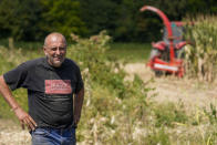 A farmer Zlatko Kokanovic stands in his corn field in the village of Gornje Nedeljice, in the fertile Jadar Valley in western Serbia, Tuesday, Aug. 6, 2024. (AP Photo/Darko Vojinovic)