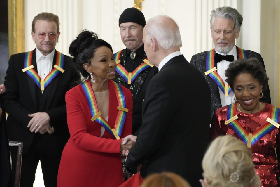 President Joe Biden shakes hands with performer Gladys Knight during the Kennedy Center honorees reception at the White House in Washington, Sunday, Dec. 4, 2022. Composer and conductor Tania León, right, and back row from left, Irish band U2 members, Bono, The Edge and Adam Clayton, look on. (AP Photo/Manuel Balce Ceneta)