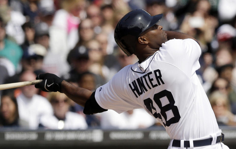 Detroit Tigers' Torii Hunter watches his solo home run off Baltimore Orioles starting pitcher Chris Tillman during the fourth inning of a baseball game in Detroit, Sunday, April 6, 2014. (AP Photo/Carlos Osorio)