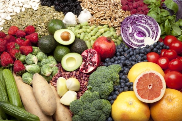 Large grouping of healthy superfoods, including strawberries, Brussels sprouts, chickpeas, blackberries, walnuts, blueberries, p