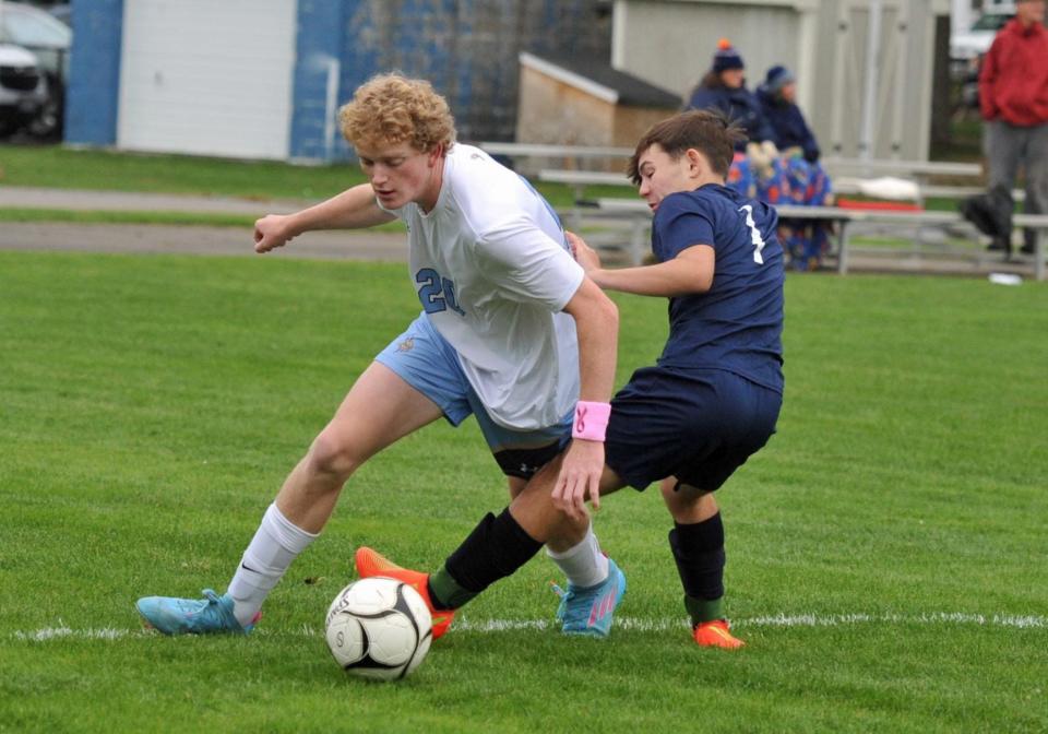 Rockland's Kaiky Araujo, right, steals the ball from East Bridgewater's Aidan Toomey, left, during boys soccer at Rockland High School, Monday, Oct. 3, 2022.