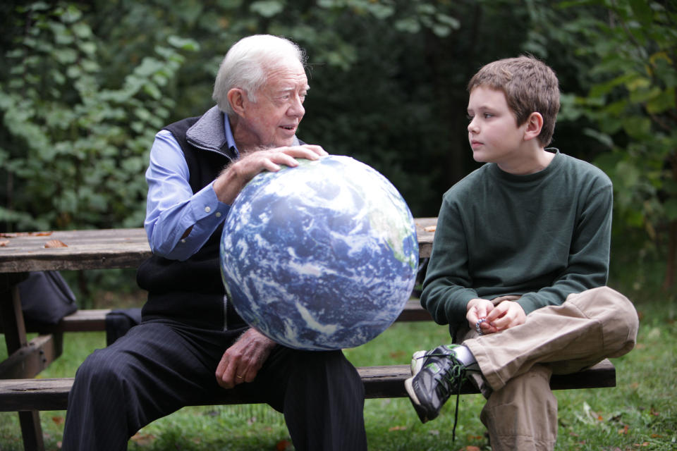 FILE: In this handout image provided by the Elders, Jimmy Carter talks with his grandson Hugo Wentzel, 10, during a picnic event on Oct. 31, 2009 in Istanbul, Turkey. / Credit: Jeff Moore/The Elders via Getty Images