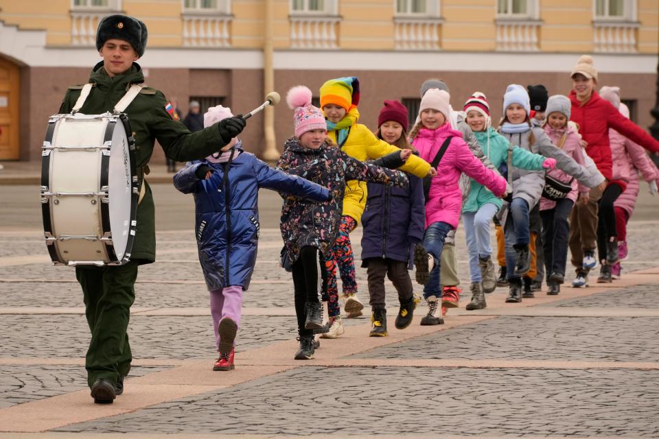 Children march following a drummer of a military band during a rehearsal for the Victory Day military parade which will take place at Dvortsovaya (Palace) Square on May 9 to celebrate 77 years after the victory in World War II in St. Petersburg, Russia, on April 14, 2022.