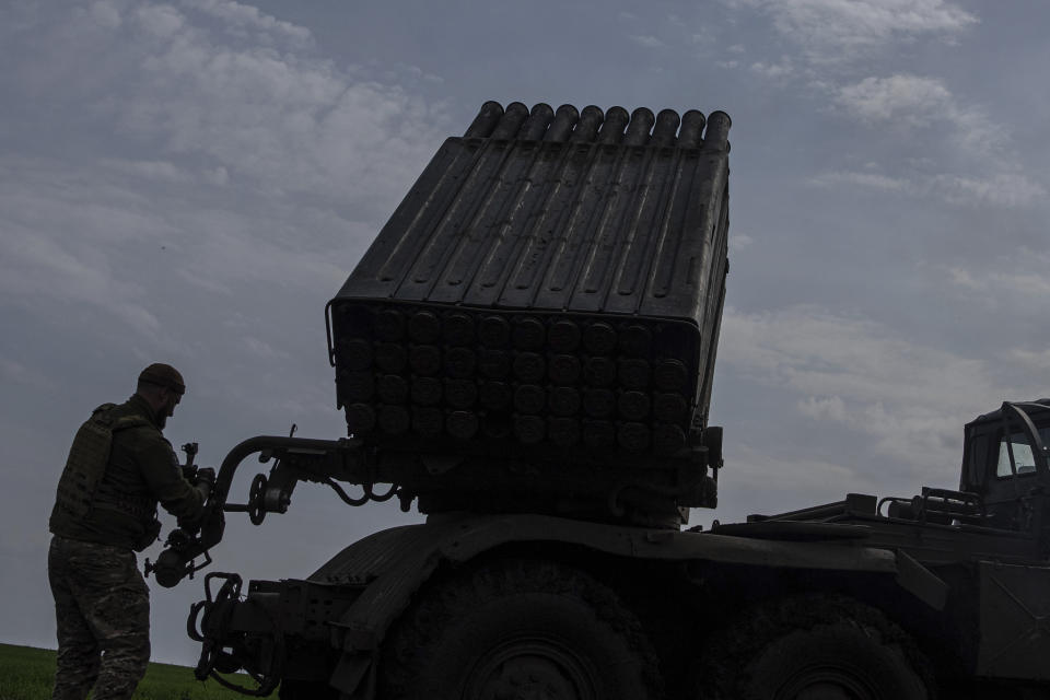 A Ukrainian serviceman aims to fire a MSLR BM-21 "Grad" towards Russian positions, at the frontline in Donetsk region, Ukraine, on Saturday, April 8, 2023. (AP Photo/Evgeniy Maloletka)