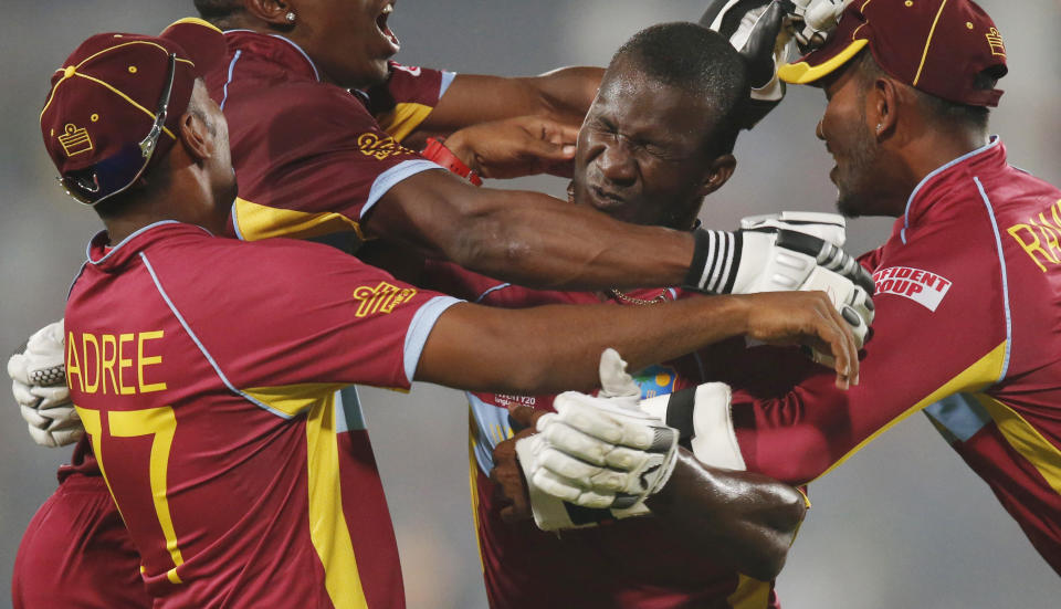 10ThingstoSeeSports - West Indies' players pounce on captain Darren Sammy, second right, to celebrate their win over Australia in the ICC Twenty20 Cricket World Cup match in Dhaka, Bangladesh, Friday, March 28, 2014. West Indies won the match by six wickets. (AP Photo/Aijaz Rahi, File)