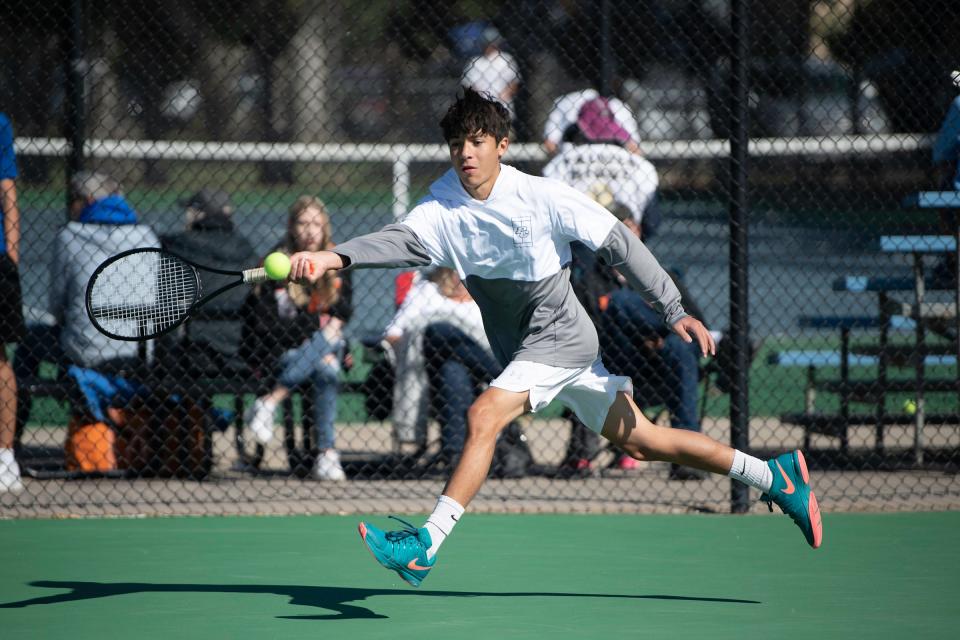 Pueblo County High School’s No. 2 doubles Brayden Gonzales stretches on a return during the first round of the Class 4A state tournament on Thursday, October 14, 2021 at Pueblo City Park.