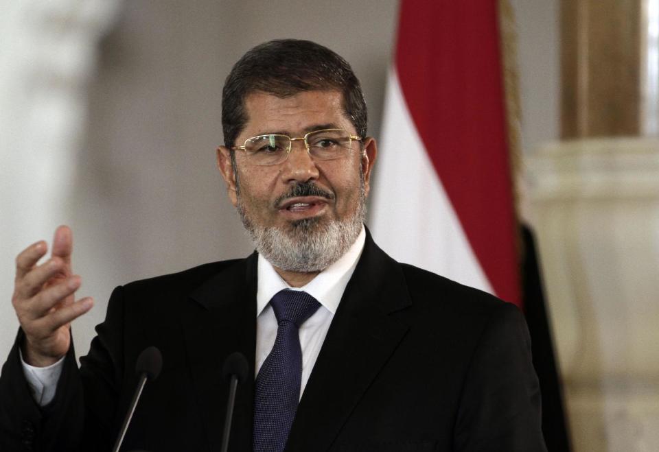 FILE - In this July 13, 2012 file photo, then Egyptian President Mohammed Morsi speaks to reporters at the presidential palace in Cairo. Egypt's state news agency says Morsi has arrived in Cairo for a trial over prison breaks in 2011. (AP Photo/Maya Alleruzzo, File)